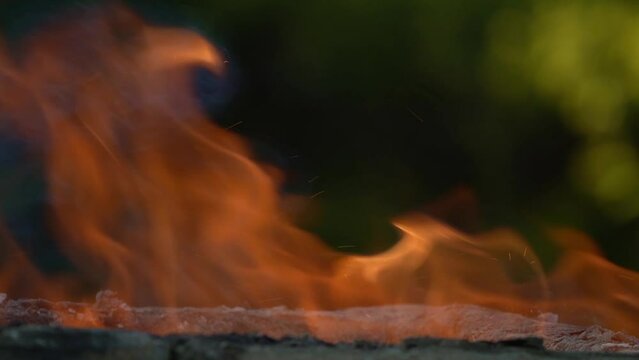 Slow motion of the Fire burns continuously, as the spark from the fire shows. For flame and heat background or any dynamic power background.