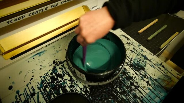 Mixing emulsion for screen printing with spatula on messy table