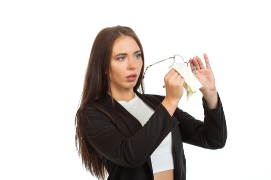 A business lady is wiping her glasses. Isolated on white background.
