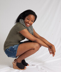 Lovely woman squatting with a smile