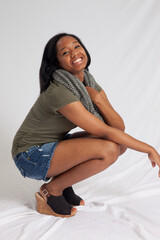Lovely woman squatting with a smile