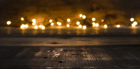 Blurred Christmas lights on a wooden background