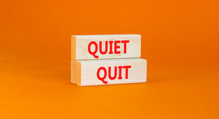 Quiet quit symbol. Concept words Quiet quit on wooden blocks. Beautiful orange table orange background. Business and quiet quit concept. Copy space.