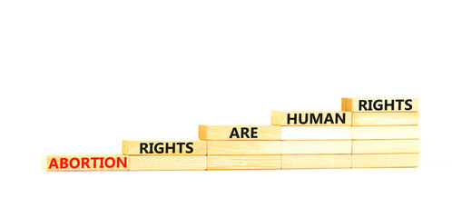 Abortion rights symbol. Concept words Abortion rights are human rights on wooden blocks. Beautiful...