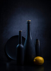 Modern still life with black bottles and lemon in blue tones © 02irina
