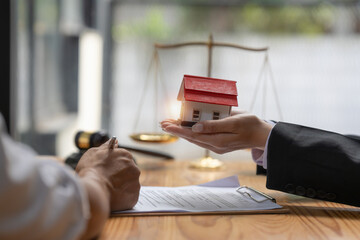 Close up Business woman or Real Estate agent explain signing agreement for buying house. Bank...