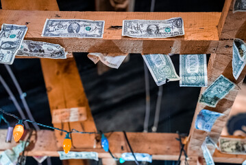 Yellowstone National Park, USA. September 16, 2022. Signatures on currencies on wooden ceiling of restaurant. Dollar bills stuck on planks over lights at hotel in Yellowstone national park.