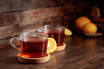 Tea with lemon on a wooden table.