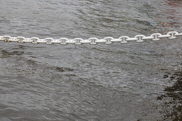 White anchor chain on the background of water.Background image.