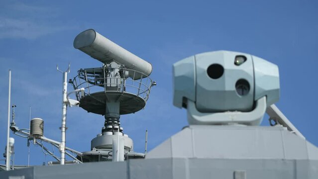 Image of a military radar air surveillance on navy ship tower.