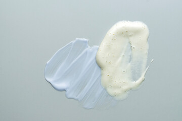 Assortment of cosmetic mask or cream balm and cleansing foam on gray background. Skin careproducts textures