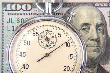 mechanical stopwatch on the background of dollars. Part time accuracy for business. business and...