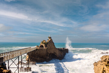 Sunset on the famous rock of the Virgin in the city of Biarritz on the Basque coast - obrazy, fototapety, plakaty