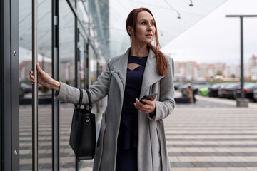 female actuary in business clothes at the entrance to the business center