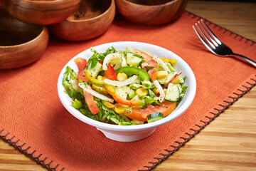 Marmaris Mixed Salad with cucumber. corn, tomato and green leaves served in dish isolated on table side view of middle east food