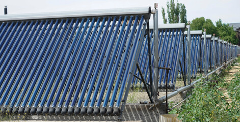 New generation solar cells.  Closeup of vacuum solar water heating system in the row. Solar Hot Water. © Maxim Chuev
