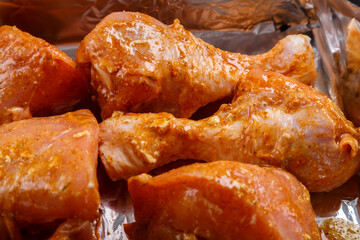 chicken drumsticks marinated in soy sauce and spices on foil.