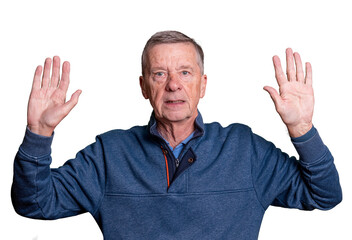 Senior adult male with hands raised and worried expression as he surrenders to his fate