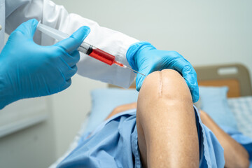 Asian doctor inject Hyaluronic acid platelet rich plasma into the knee of senior woman to walk...