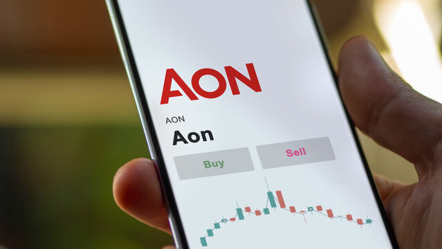 September 13th 2022, New York. An investor's analyzing the Aon AON stock on screen. A phone shows the aon prices to invest