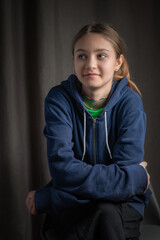 Portrait of a beautiful blonde girl in a home photo studio.