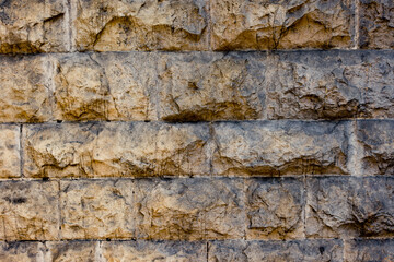 Exterior wall of an old castle, citadel, fortress or mansion made of stones and concrete