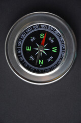 Metal compass on a black background. Close-up.