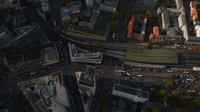 High angle view of traffic on railway line and in streets of urban borough. Train leaving Zoologischer Garten railway station. Charlottenburg neighbourhood, Berlin, Germany
