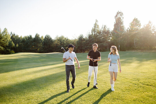 friends on golf court talking, shares his impressions after playing golf. . High quality photo