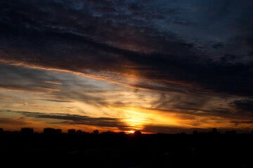 Dramatic sunset sky with clouds over the city