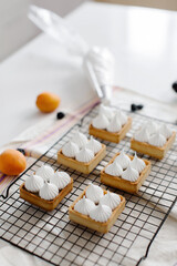 meringue desserts with delicious berries and fruits in the kitchen. High quality photo
