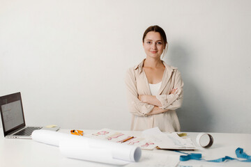 Seamstress at work. Dressmaker making clothes in modern studio. High quality photo