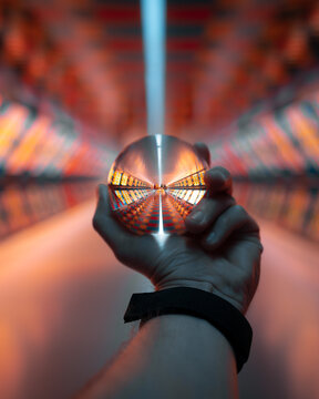 Hand holding a Lensball in a pedestrian tunnel