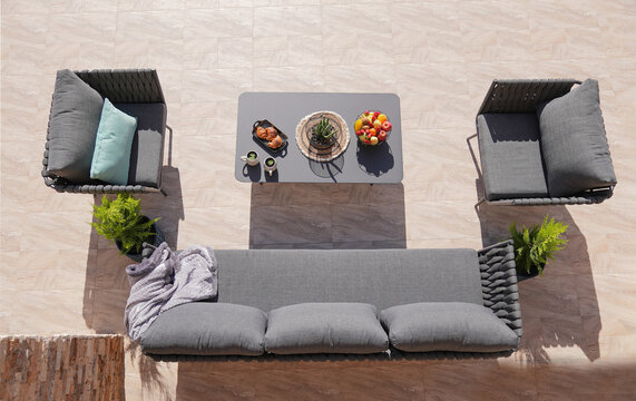 3 Gray Sofa And A Table Made Of Metal In The Courtyard And Garden On The Garden Tiles,comfortable Sofa,shot From Above
