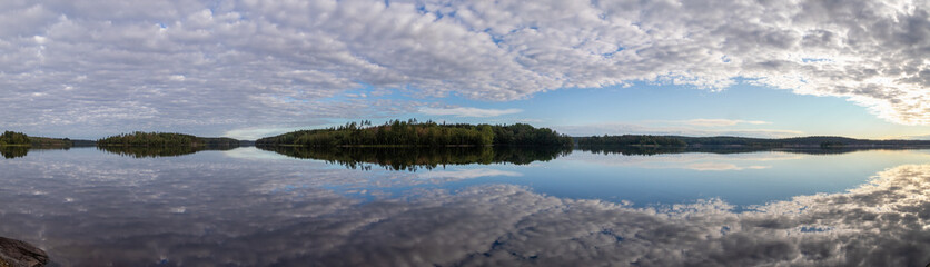 Sunrise over Ladoga lake landscape with cloudy sky panorama