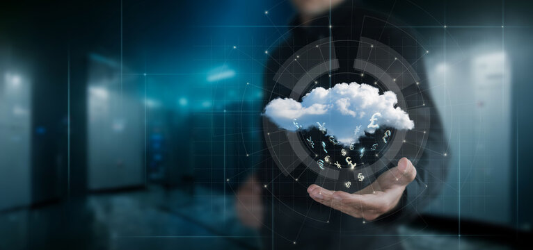 Businessman showing data cloud with flying currency symbols .