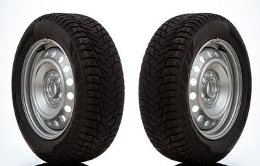 Car wheel and winter studded tire on white