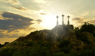 Resurrection. Three Christian crosses on a mountain with sunset. Religion and church symbol of...