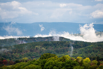 Morning fog clouds sky weather rising mist in early fall autumn foliage season on road to Dolly Sods, West Virginia mountains near Wardensville, WV