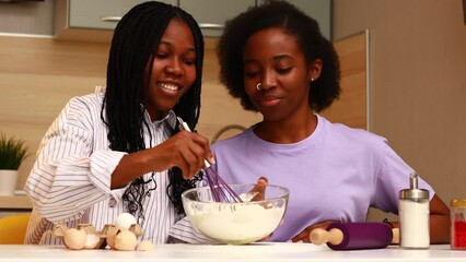 happy african american couple in love making a rainbow cake at home - Powered by Adobe