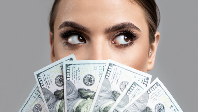 Woman With Dollars In Hand. Portrait Woman Holding Money Banknotes. Girl Holding Cash Money In Dollar Banknotes. Woman Holding Lots Of Money In Dollar Currency. Luxury, Beauty And Money Concept