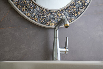 Interior of bathroom with sink basin faucet. Open chrome faucet washbasin. Modern design of...