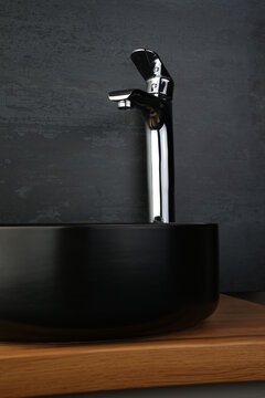 Mid-century Modern Bathroom With Polished Chrome Faucet And Black Washbasin
