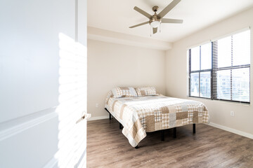 Bedroom room interior nobody with open door in new modern luxury apartment home house with window bright natural light hardwood laminate floor and ceiling fan - Powered by Adobe