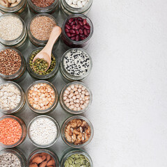 Vegan source of protein. healthy vegetarian food. top view of seeds, nuts, peas, beans, spelt, oatmeal on white background copy space square