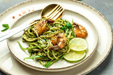 Pasta spaghetti zucchini basil pesto sauce and grilled shrimp, Vegetarian vegetable pasta, Food recipe background. Close up