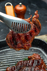 Juicy Beef steak with rosemary and spices. Grilled meat, bbq, barbecue. vertical image. place for text