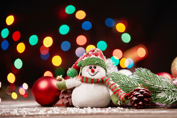 cute funny snowman on Christmas evening background.