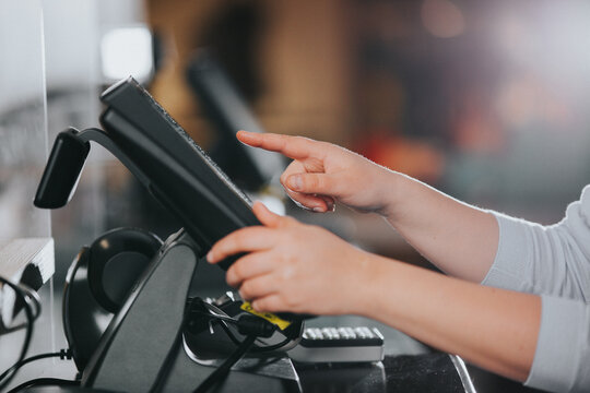 POS concept, young woman hand doing process payment on a touchscreen cash register, finance, shopping concept