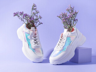 White sneakers with sequins with flowers on purple geometric background - 544705688